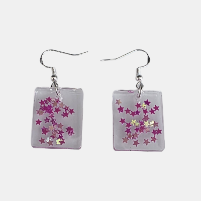 Handgemaakte vierkante epoxy oorbellen van heldere transparante hars met een speelse vulling van glanzende roze sterretjes en zilveren oorhaken.