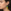 Lifestyle foto aqua en gele gradient oorbellen Close-up van een vrouw die een langwerpige driehoekige oorbel draagt met een kleurverloop van aqua groen naar felgeel